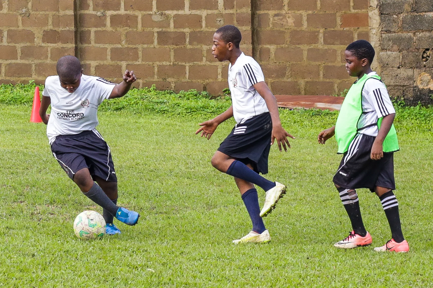 Young Concord Football Academy players contesting the ball during training