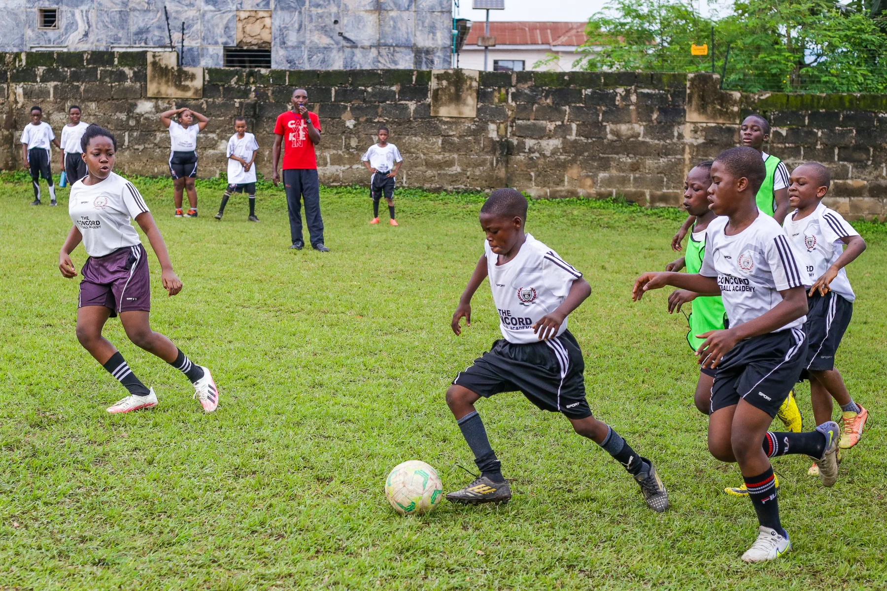 Academy players competing for the ball in training