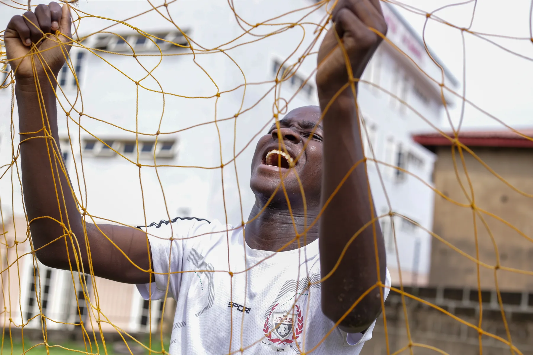 Player standing behind a goal net
